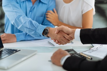 advisor and clients shake hands